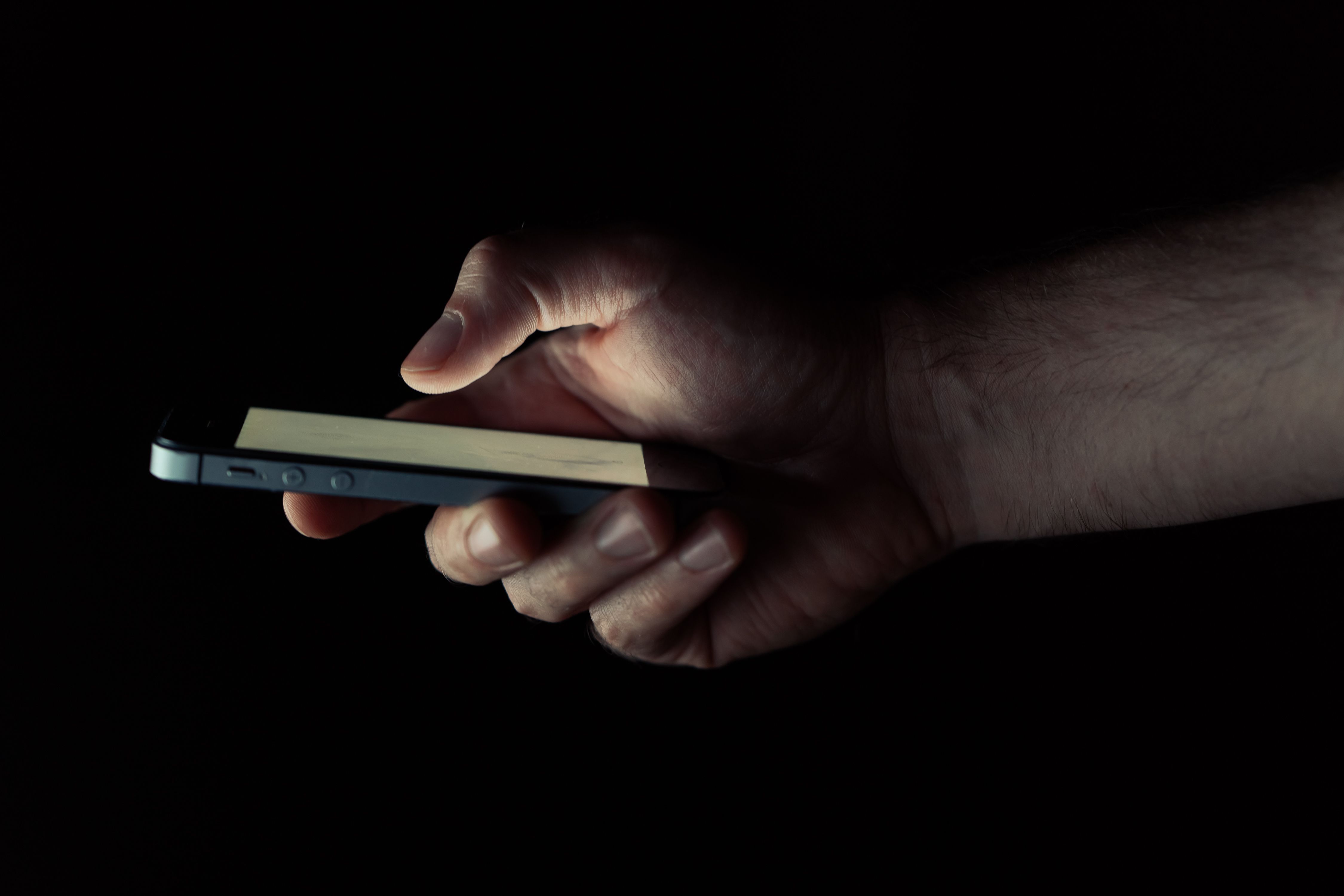 Close up of person using Report Fraud on smartphone