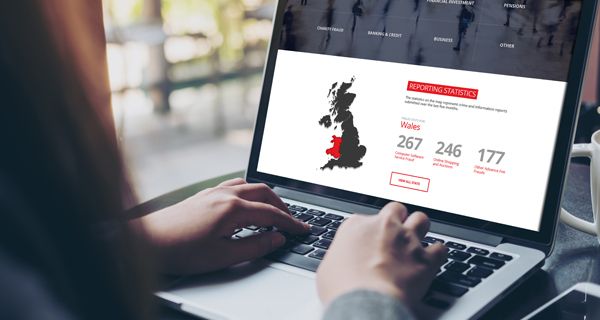 Woman with open laptop showing map of UK